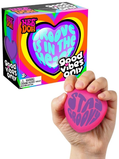 Groovy Heart squishy toy held in hand with packaging